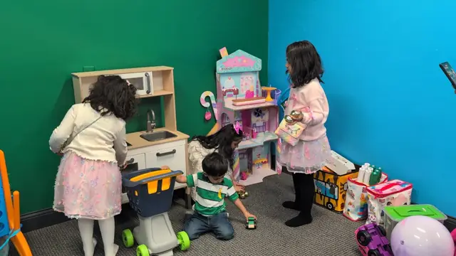 Kids playing with dollhouse and toys