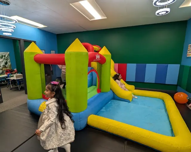 Kids on bounce house with slide